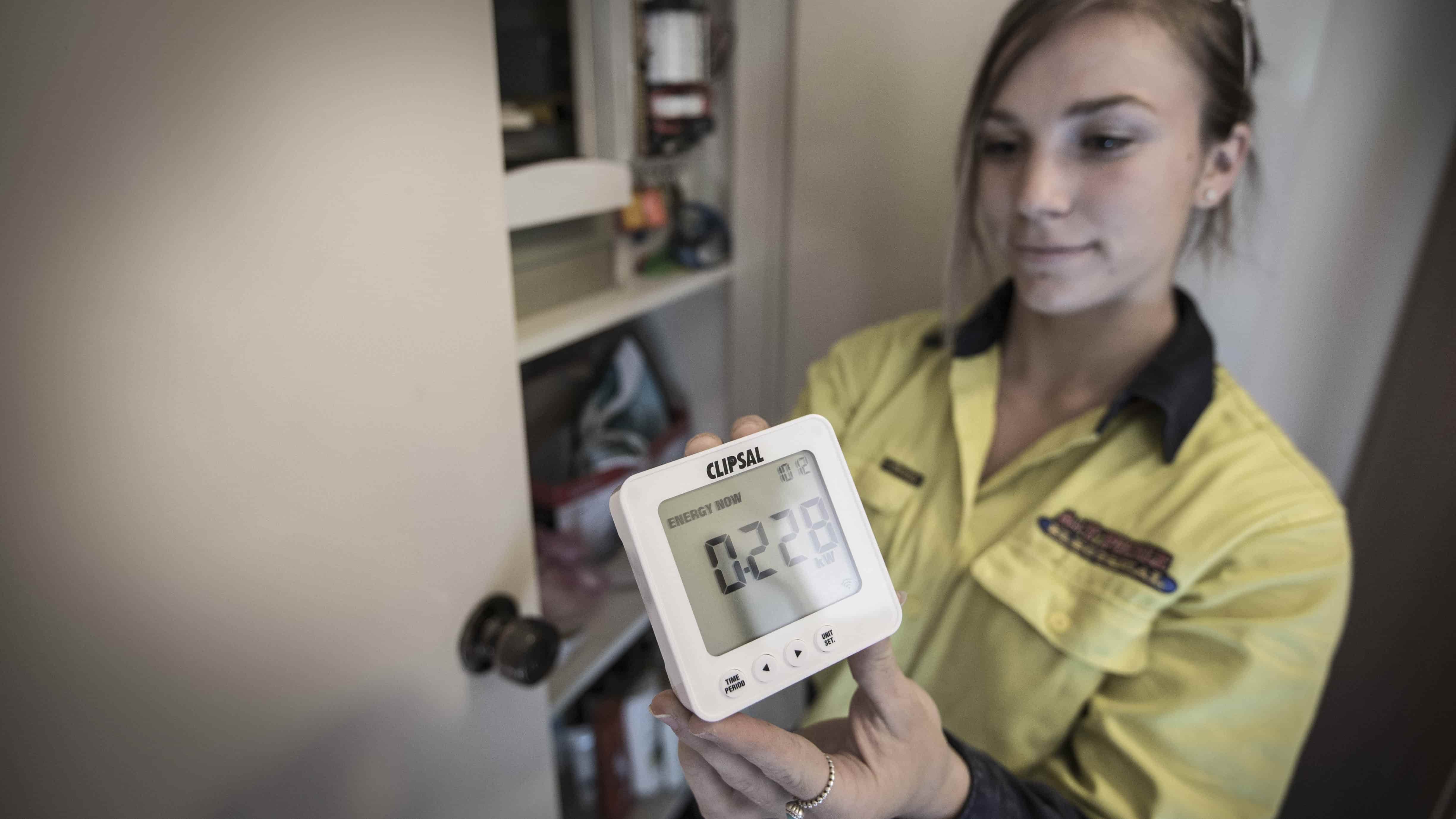 Electrician Shauna Milligan with a power meter. Photo: Paul Jones